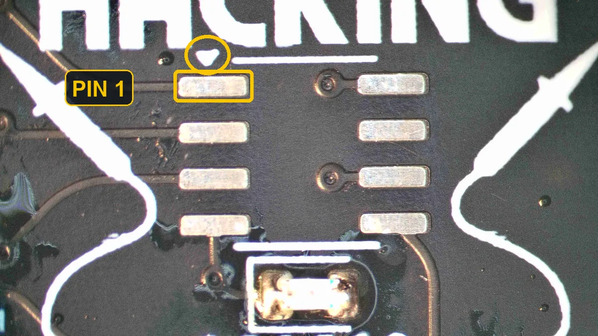 The eight empty EEPROM pads; the small white triangle above the top-left pad is circled and that pad is labelled pin 1