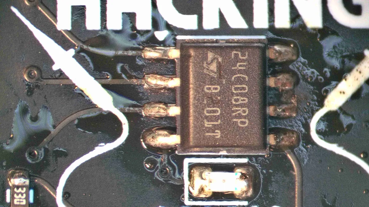 All eight legs soldered, the board shiny with flux residue
