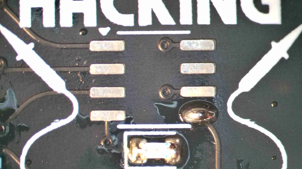 The EEPROM pads with a solder blob on the bottom-right pad only