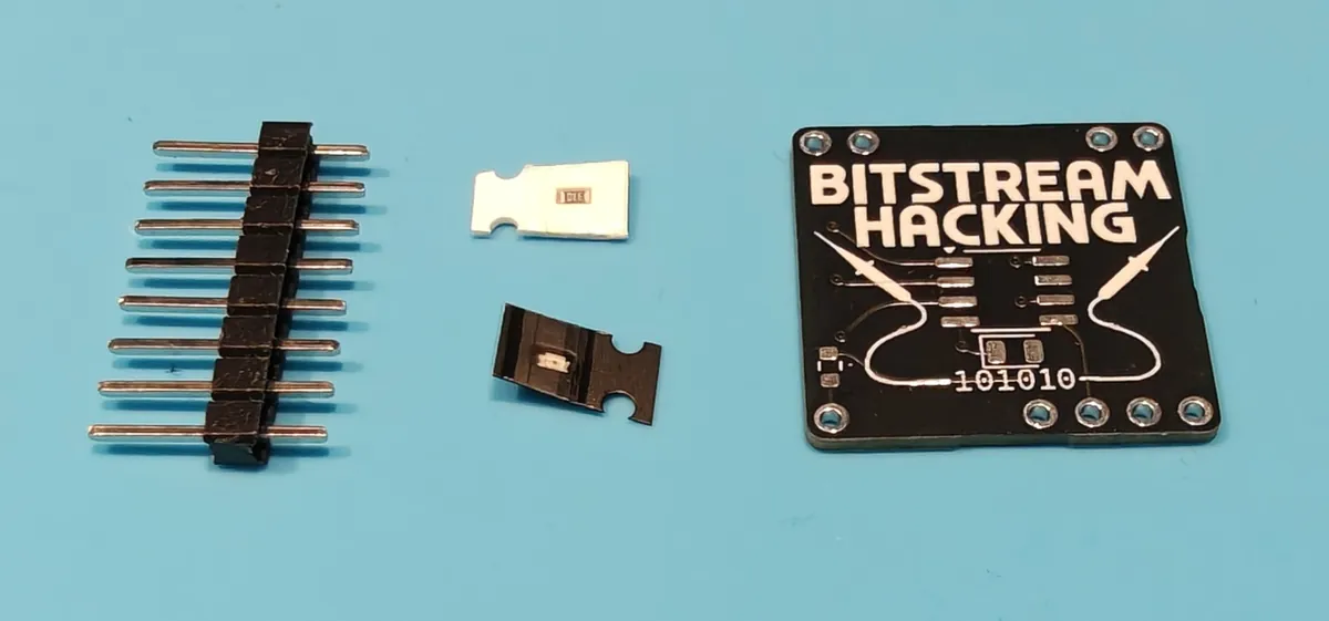 Minibadge kit: a pin header strip, a resistor and an LED in cut tape, and the bare Bitstream Hacking board