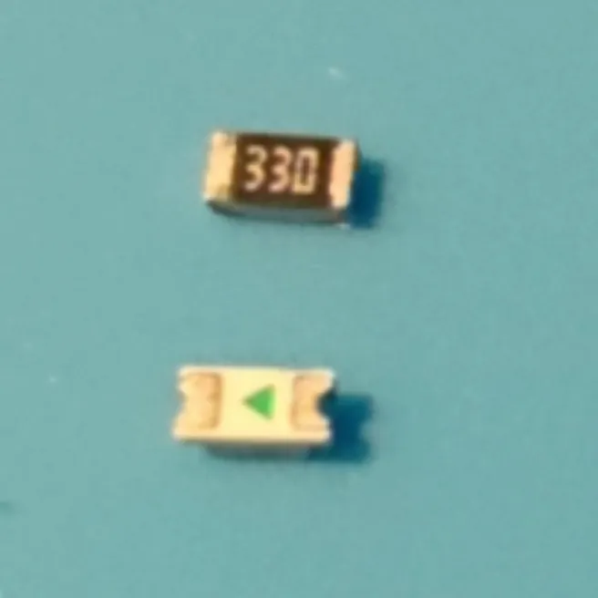 Close-up: the resistor marked 330 above the LED's underside, which has a green triangle